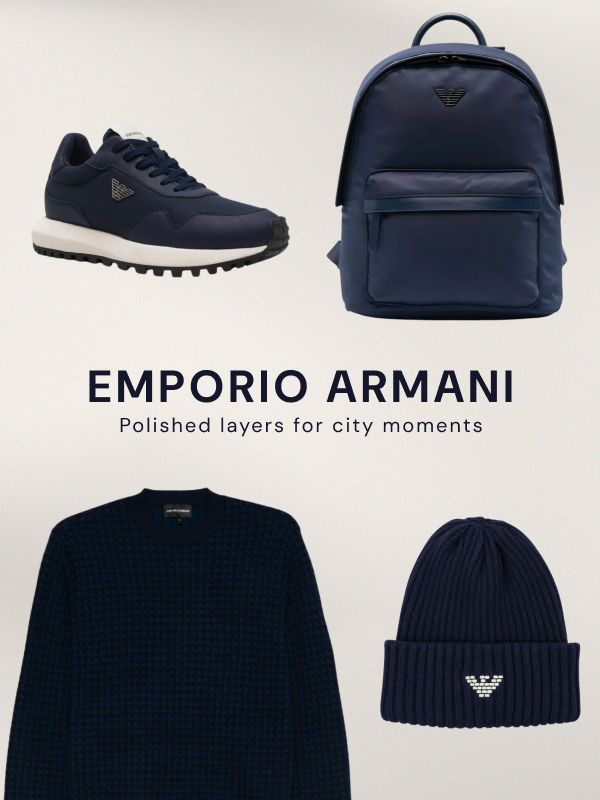 "Emporio Armani" collection featuring four items: navy sneaker, navy backpack, dark navy sweater, and navy ribbed beanie with eagle logo. Tagline: "Polished layers for city moments."