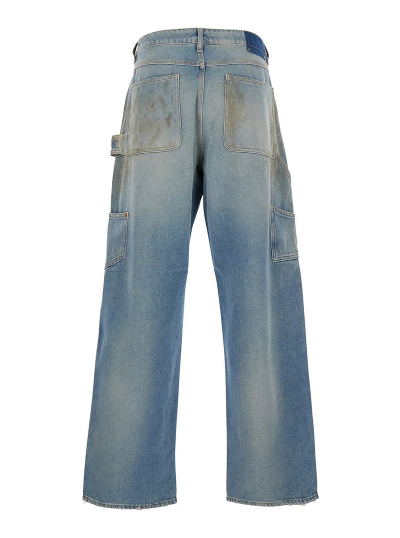 Light Blue Jeans With Ripped Details And Distressed Effect In Denim Man